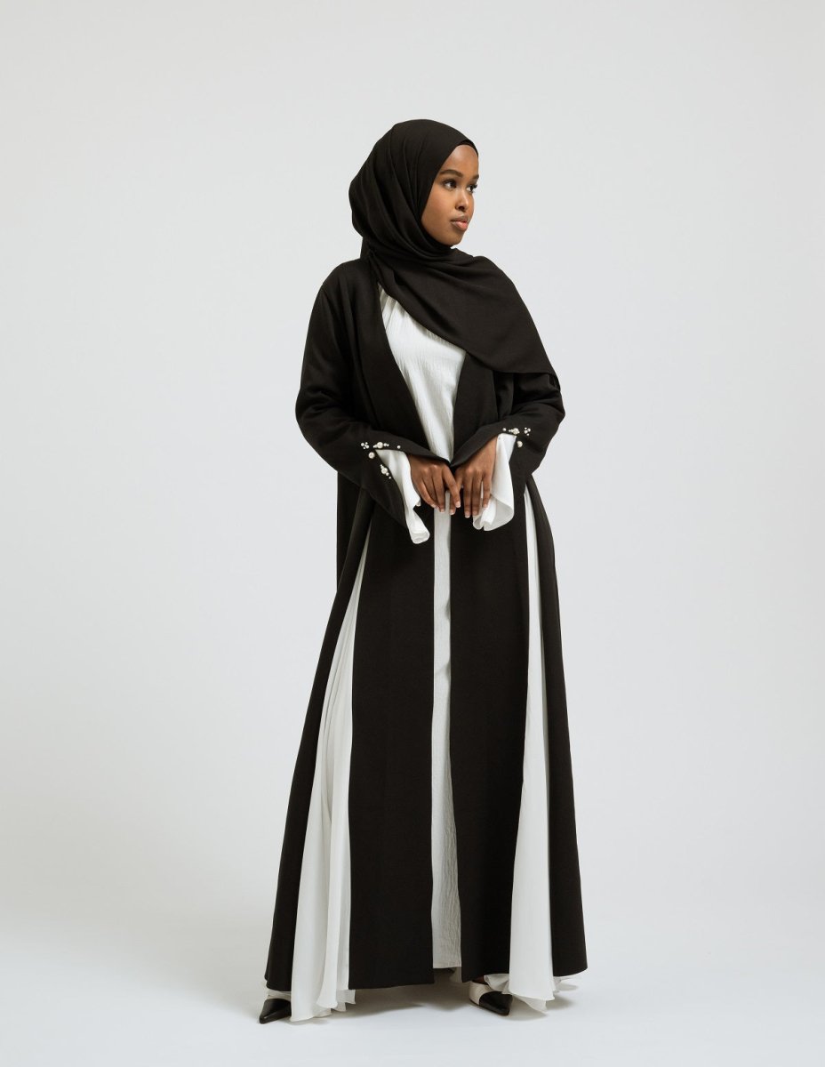 Elegant black and white Perla abaya with pearl sleeve details- Leyannaco